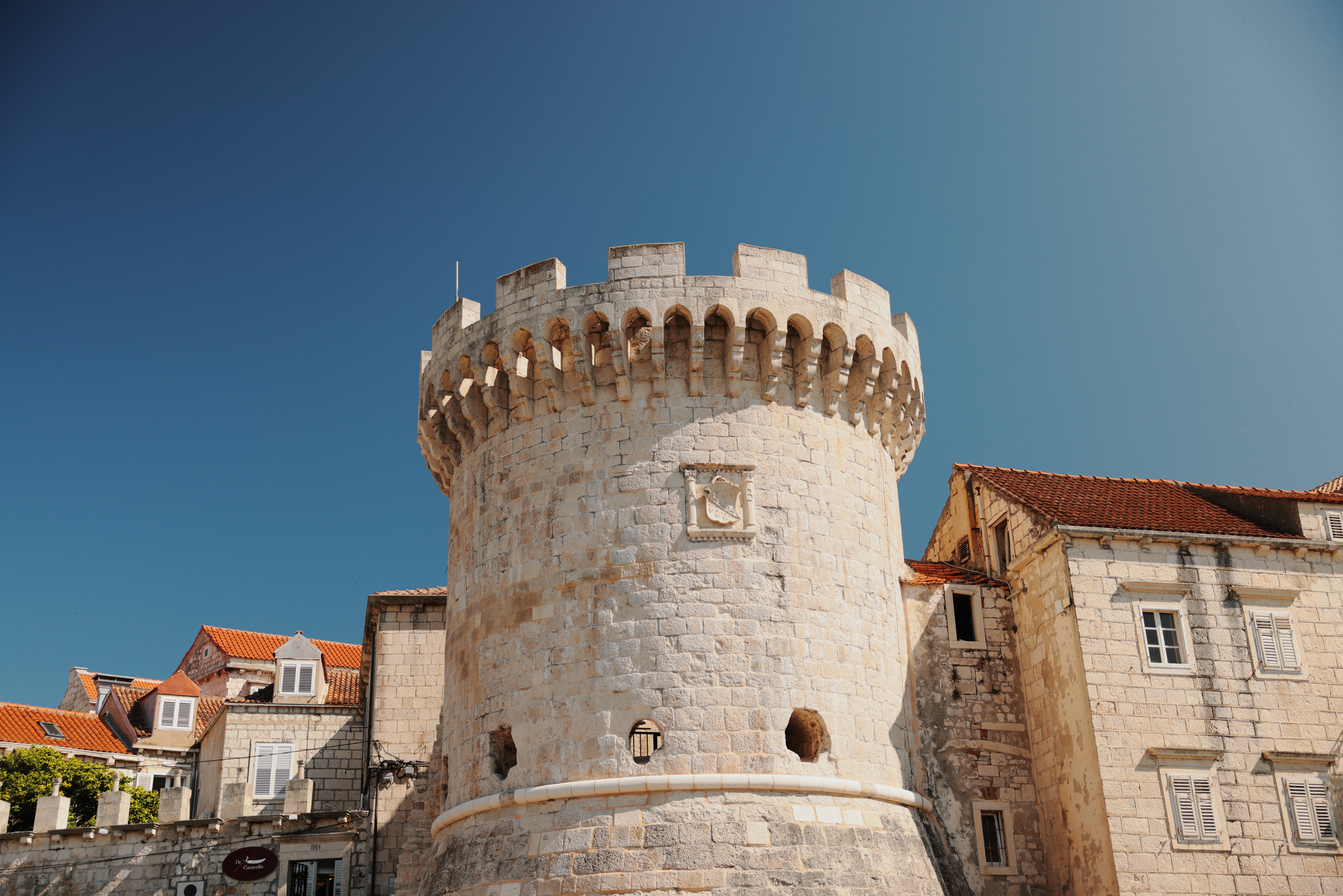 Croatian fortress tower rising above red-tiled rooftops — architecture that lasts